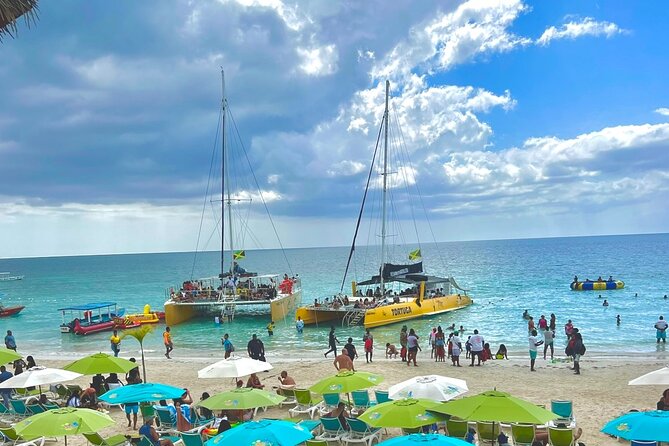 7 Mile Beach Party Catamaran Cruise with Snorkeling & Ricks Cafe - Key Highlights at a Glance