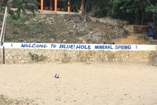 Blue Hole Mineral Springs, Rick's Café, and Shopping Combo Tour - Rick’s Cafe: Sunset Energy Plus the Iconic Cliff Jump Scene