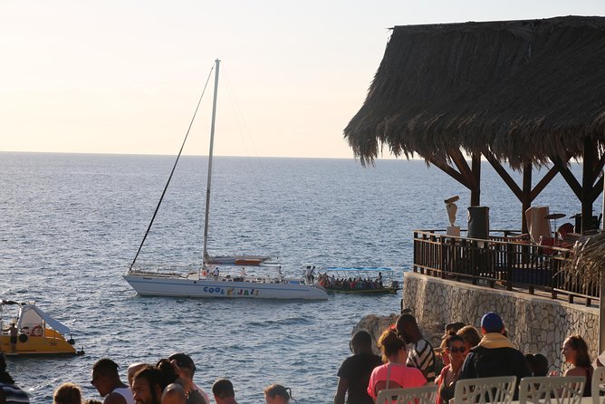 Negril 7 Mile Beach & Ricks Cafe Sunset Tour (Private ) - Rick’s Cafe in the afternoon: music, food, pool, and sunset